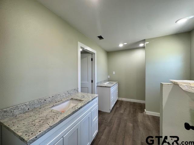 bathroom with vanity and hardwood / wood-style floors