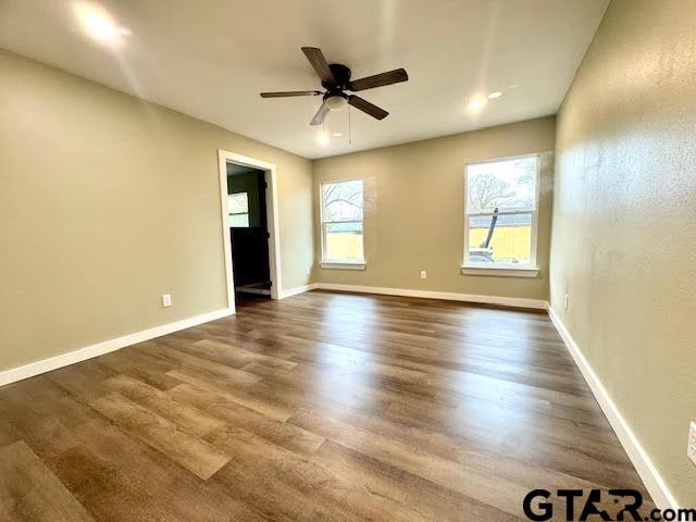 641 N Weldon St, Frankston, TX 75763 - unfurnished room featuring dark wood-style floors, ceiling fan, and baseboards