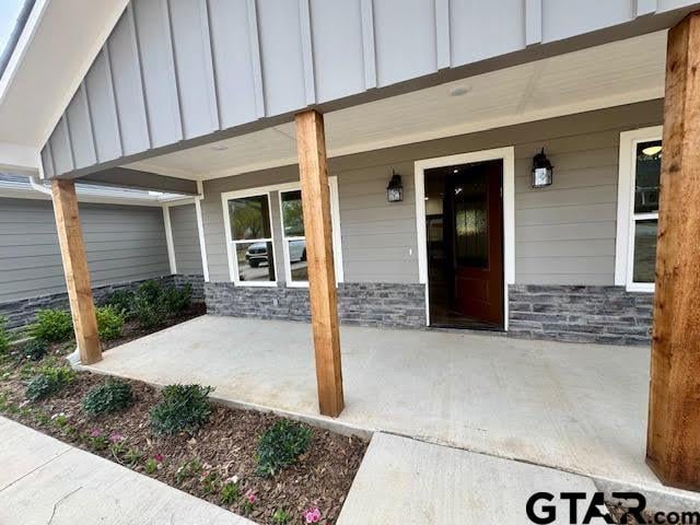 641 N Weldon St, Frankston, TX 75763 - property entrance with board and batten siding, a porch, and stone siding