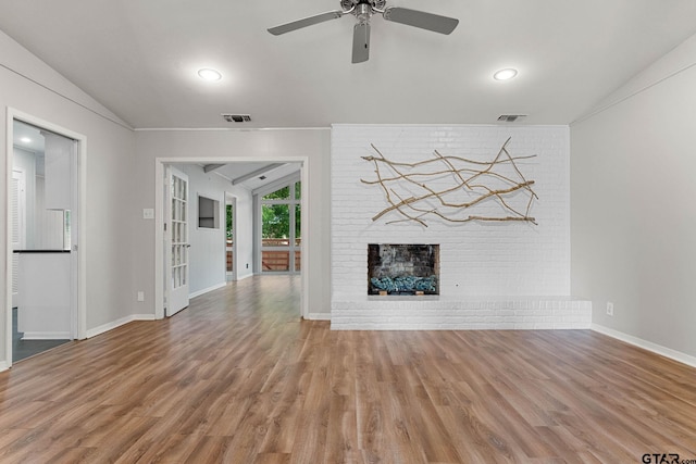 3200 Decharles St, Tyler, TX 75701 - unfurnished living room featuring vaulted ceiling, a brick fireplace, wood finished floors, a ceiling fan, and baseboards