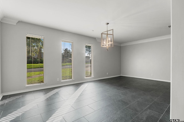 3200 Decharles St, Tyler, TX 75701 - spare room featuring a chandelier, baseboards, ornamental molding, and dark tile patterned floors
