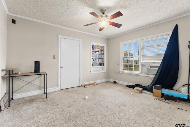 empty room with light carpet, ornamental molding, a textured ceiling, and a ceiling fan