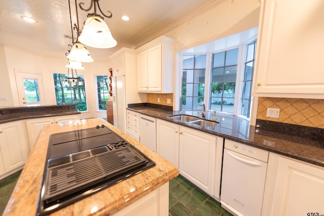 kitchen with white cabinetry, a healthy amount of sunlight, pendant lighting, and sink