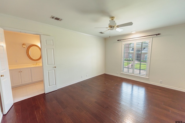 unfurnished room featuring dark hardwood / wood-style flooring, ceiling fan, and crown molding