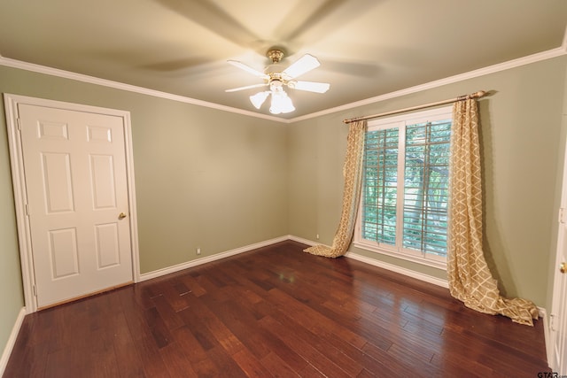 spare room with dark hardwood / wood-style flooring, ornamental molding, and ceiling fan