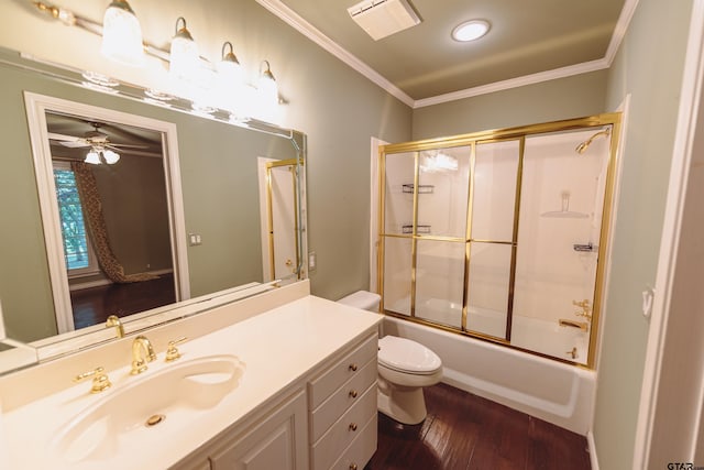 full bathroom featuring toilet, hardwood / wood-style floors, bath / shower combo with glass door, ornamental molding, and vanity