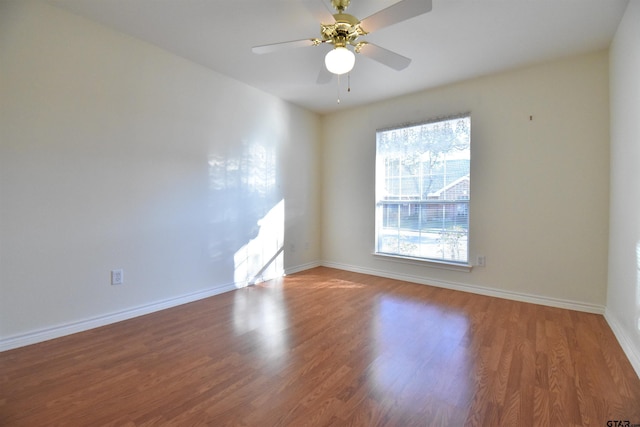 spare room with ceiling fan and wood-type flooring