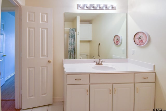 bathroom featuring tile patterned flooring, vanity, a shower with shower curtain, and toilet