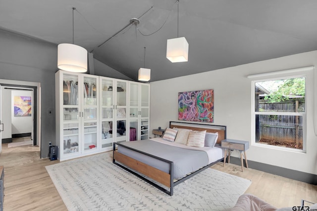 living room featuring light hardwood / wood-style floors and lofted ceiling