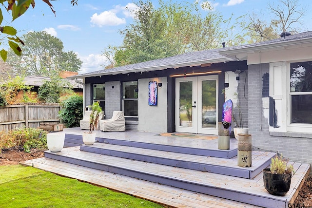 back of house featuring a wooden deck and french doors