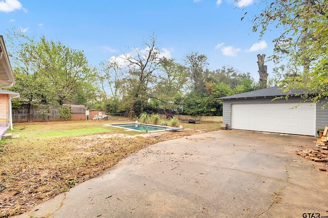 view of yard featuring a fenced in pool and a storage shed