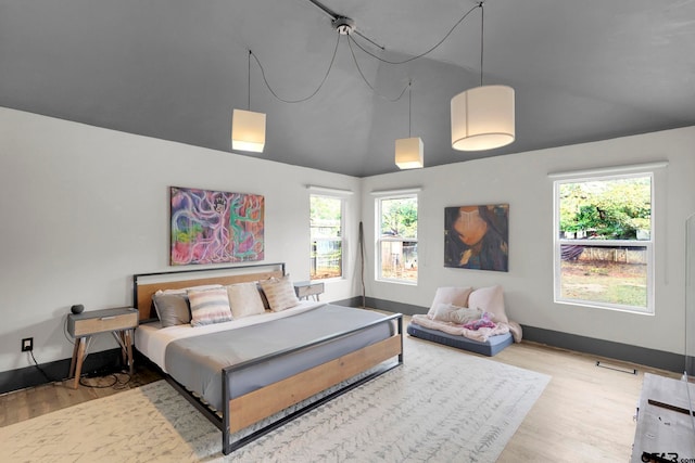 bedroom featuring hardwood / wood-style flooring and vaulted ceiling