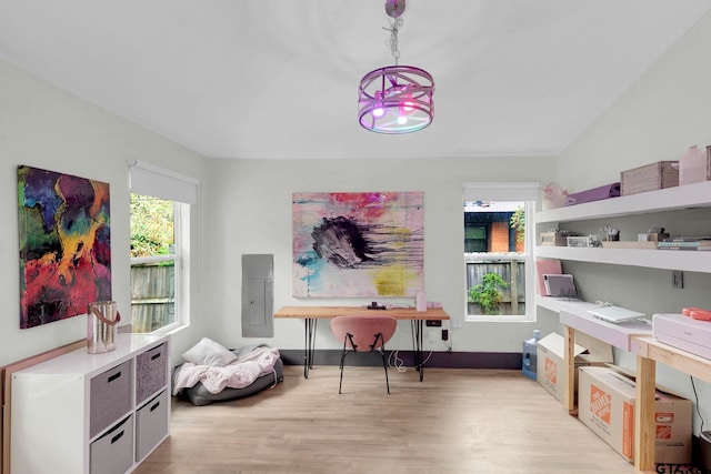 playroom featuring light hardwood / wood-style floors, lofted ceiling, and electric panel