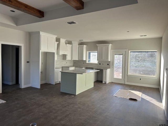 kitchen featuring custom range hood, decorative backsplash, a kitchen island, white cabinets, and beamed ceiling