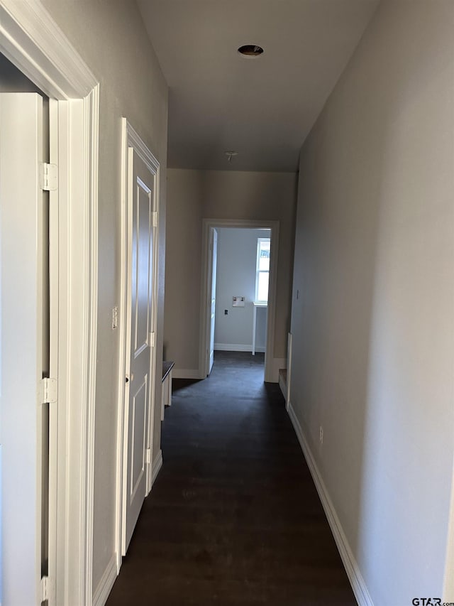 corridor with dark hardwood / wood-style floors