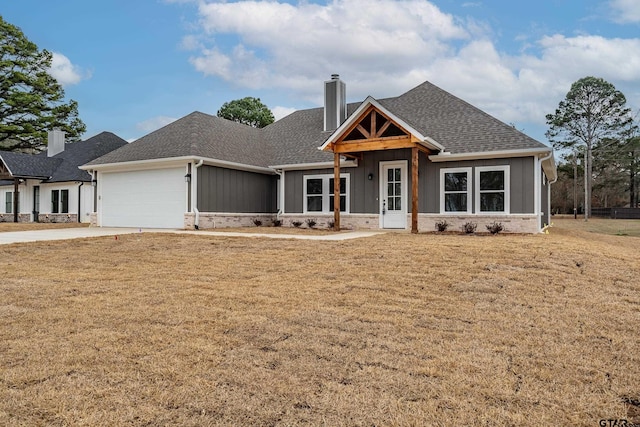 craftsman-style home featuring a garage and a front lawn