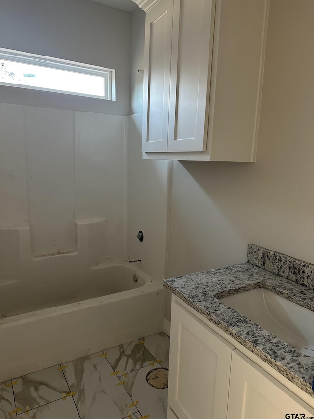 bathroom with vanity and bathing tub / shower combination