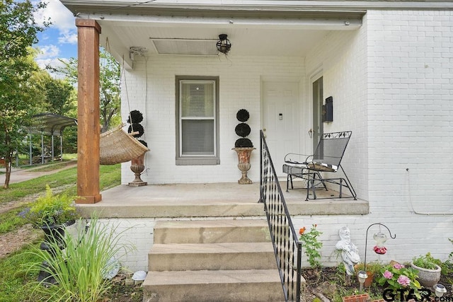 818 Rusk St, Tyler, TX 75701 - view of exterior entry featuring a porch and brick siding