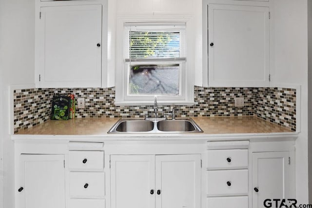 818 Rusk St, Tyler, TX 75701 - kitchen with light countertops, white cabinets, and backsplash