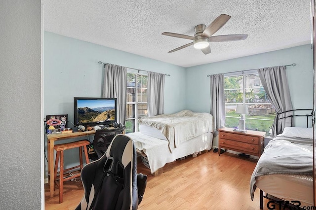 818 Rusk St, Tyler, TX 75701 - bedroom featuring a textured ceiling, light wood finished floors, and ceiling fan