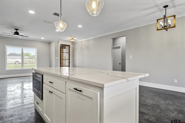 kitchen with concrete floors, white cabinetry, visible vents, baseboards, and stainless steel microwave