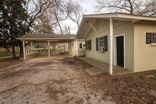 view of property exterior featuring a carport and cooling unit