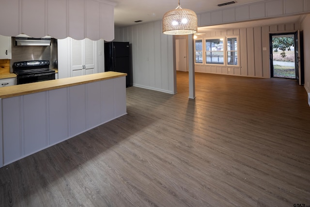 kitchen featuring hanging light fixtures, black appliances, and dark hardwood / wood-style floors