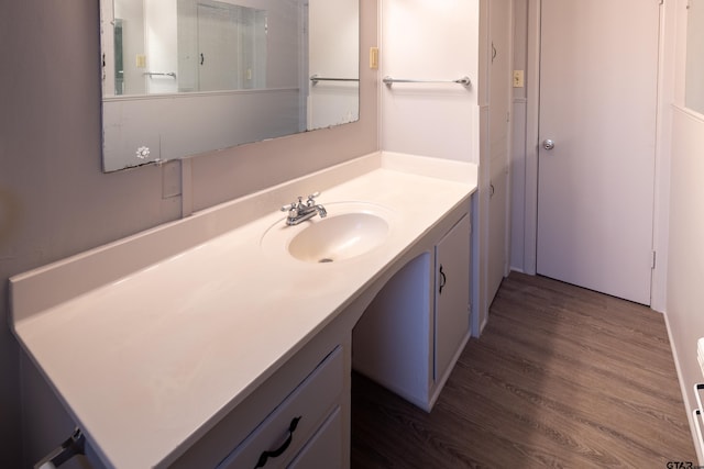 bathroom with hardwood / wood-style flooring and vanity