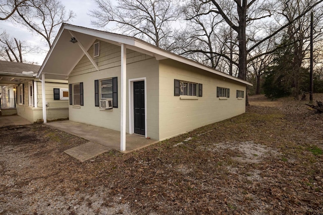 view of property exterior featuring a patio and cooling unit