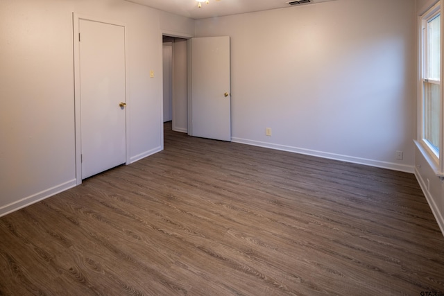 unfurnished bedroom featuring dark hardwood / wood-style floors