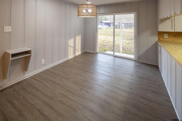 unfurnished dining area with dark hardwood / wood-style floors