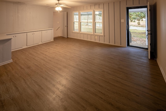 unfurnished living room featuring ceiling fan and hardwood / wood-style floors