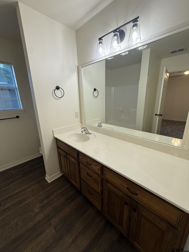 203 Macarthur St, Tyler, TX 75704 - bathroom featuring wood finished floors, vanity, baseboards, and toilet