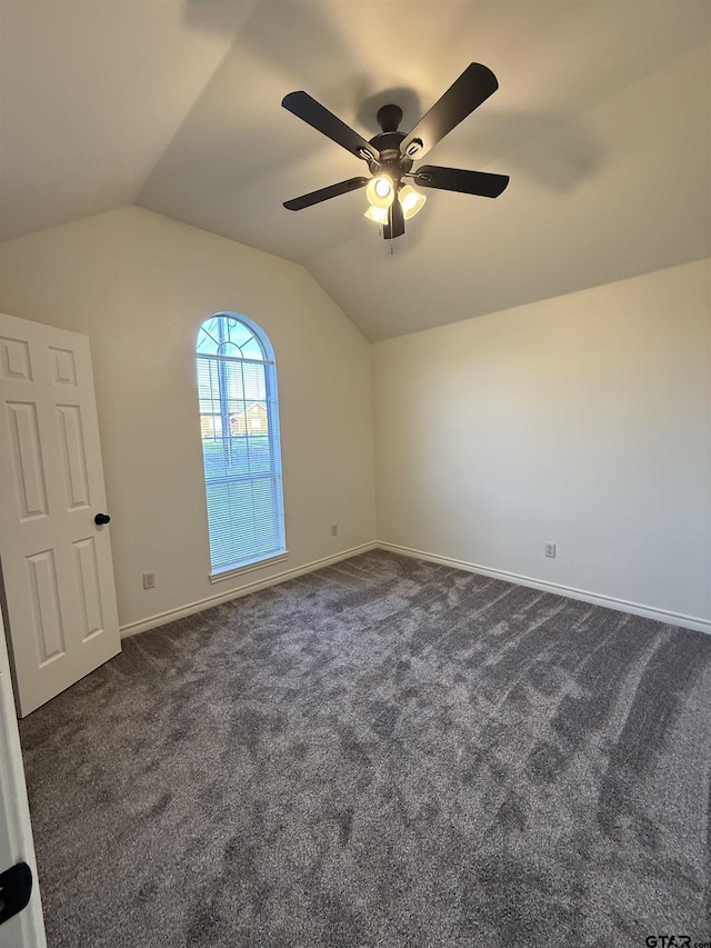 203 Macarthur St, Tyler, TX 75704 - empty room with lofted ceiling, dark colored carpet, ceiling fan, and baseboards