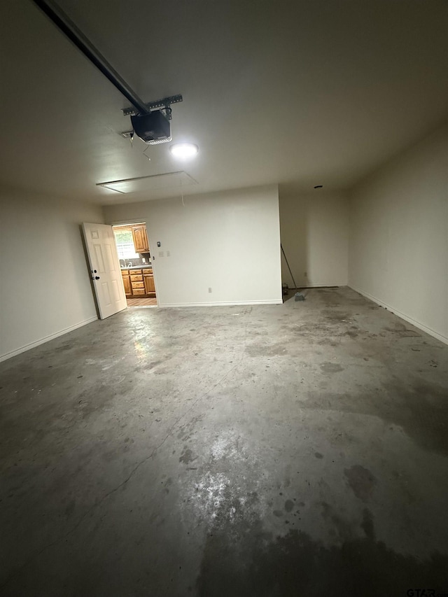 203 Macarthur St, Tyler, TX 75704 - garage featuring a garage door opener and baseboards