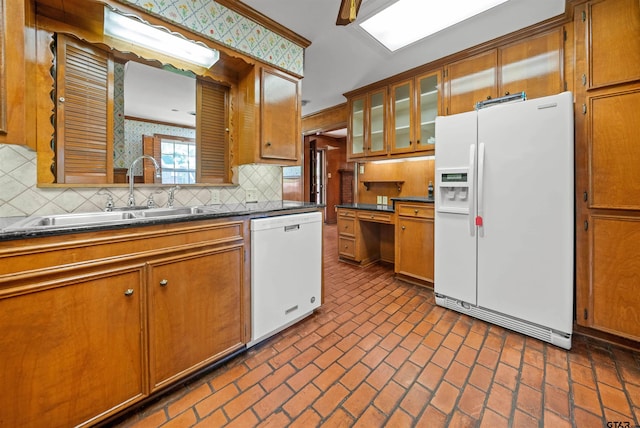 1101 Canada St, Jacksonville, TX 75766 - kitchen with white appliances, a sink, brown cabinets, and tasteful backsplash