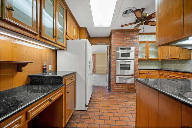 1101 Canada St, Jacksonville, TX 75766 - kitchen featuring a warming drawer, brown cabinetry, brick floors, and white refrigerator with ice dispenser