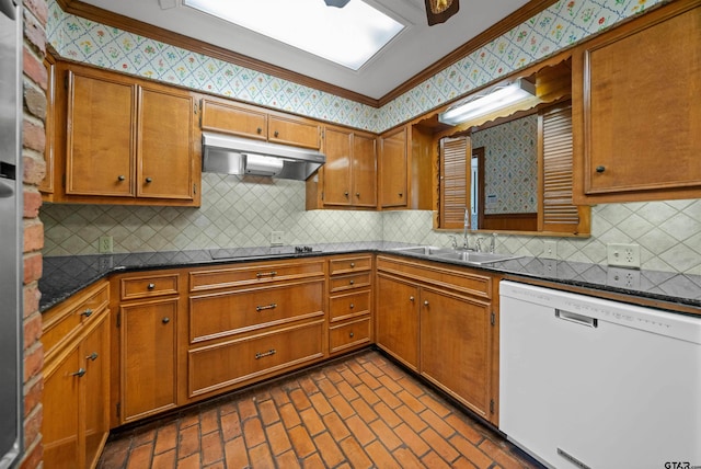 1101 Canada St, Jacksonville, TX 75766 - kitchen featuring dishwasher, under cabinet range hood, a sink, crown molding, and wallpapered walls