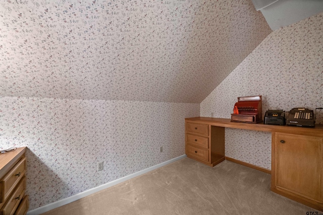 1101 Canada St, Jacksonville, TX 75766 - additional living space with wallpapered walls, light carpet, vaulted ceiling, and baseboards
