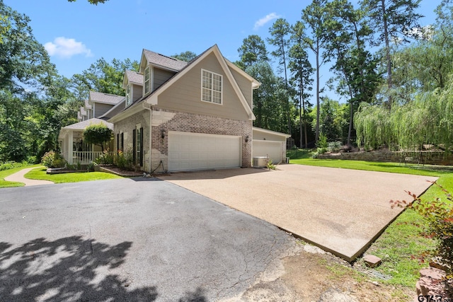 801 Wilder Way, Tyler, TX 75703 - view of property exterior with brick siding, driveway, an attached garage, and a lawn