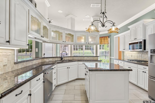 801 Wilder Way, Tyler, TX 75703 - kitchen with stainless steel appliances, tasteful backsplash, plenty of natural light, white cabinets, and recessed lighting