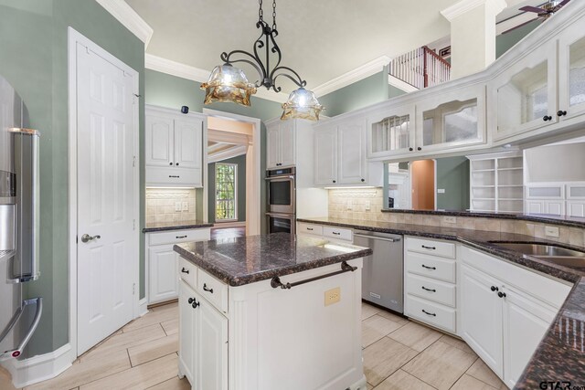 801 Wilder Way, Tyler, TX 75703 - kitchen featuring appliances with stainless steel finishes, white cabinets, backsplash, and crown molding