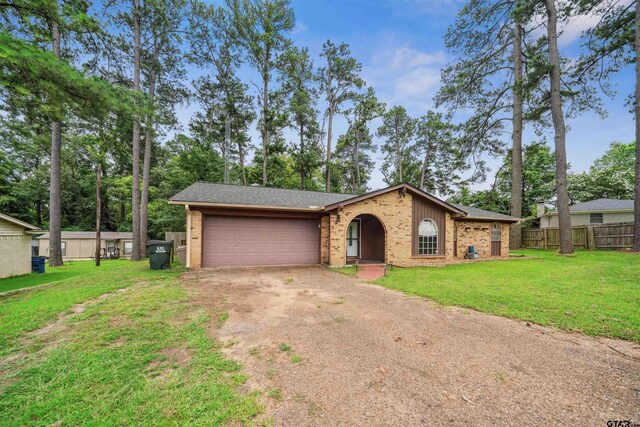 10236 County Road 2253, Tyler, TX 75707 - view of front of home with brick siding, driveway, a garage, and roof with shingles
