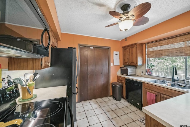 10236 County Road 2253, Tyler, TX 75707 - kitchen featuring black appliances, light countertops, brown cabinetry, light tile patterned floors, and ceiling fan