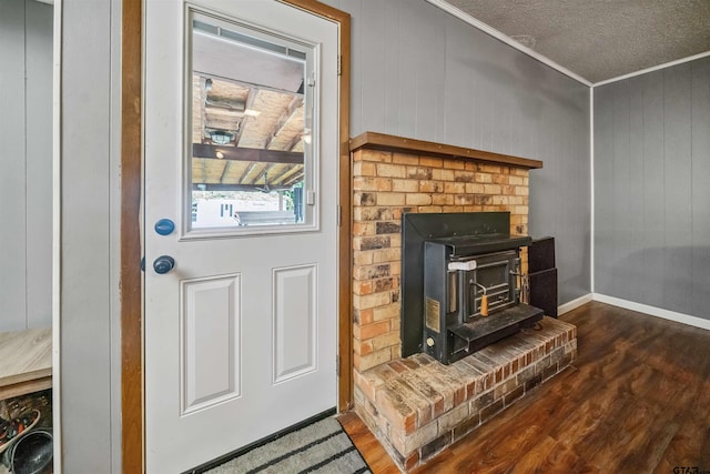 10236 County Road 2253, Tyler, TX 75707 - detailed view of wood finished floors, crown molding, and a wood stove