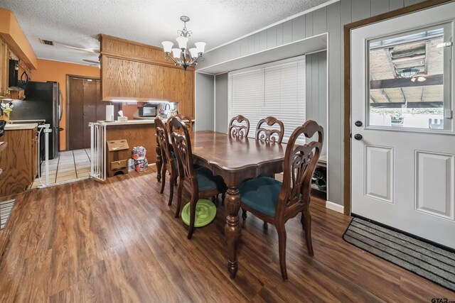 10236 County Road 2253, Tyler, TX 75707 - dining space with a chandelier, light wood finished floors, and a textured ceiling