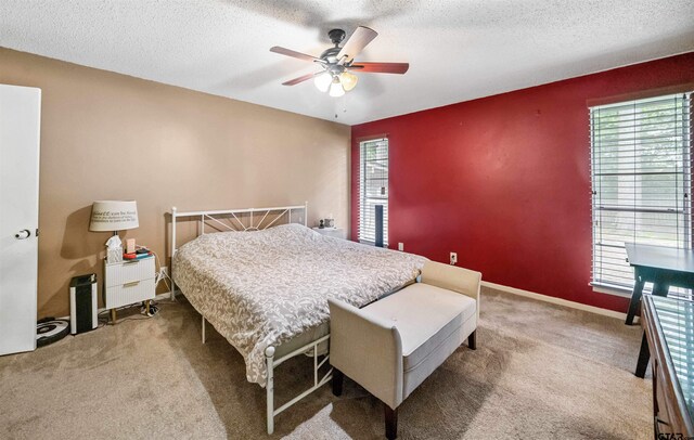 10236 County Road 2253, Tyler, TX 75707 - carpeted bedroom featuring multiple windows, a textured ceiling, and a ceiling fan