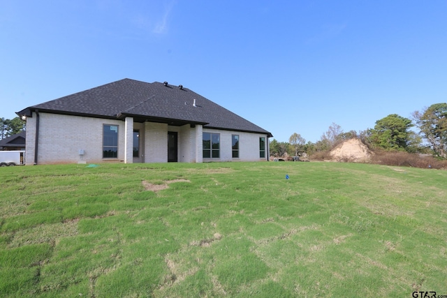 back of house featuring a yard