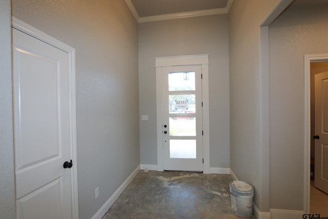 entryway with crown molding and concrete floors