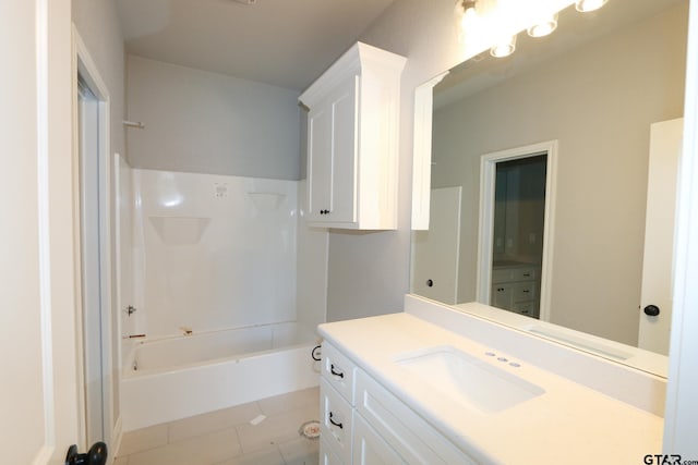 bathroom featuring tile patterned flooring, vanity, and shower / bathtub combination